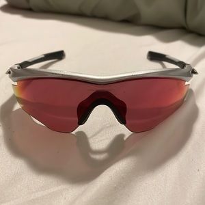 Oakley Custom M-Frame sunglasses. Silver and black. Ball field lens. Gold logo.